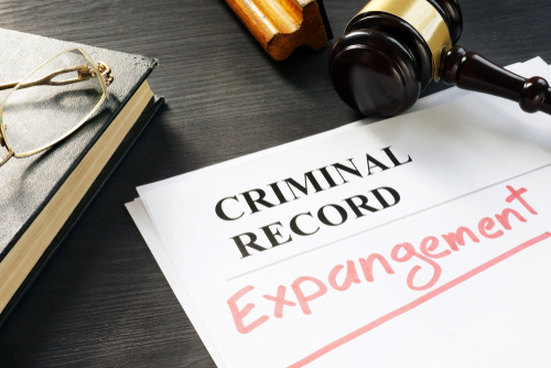 Tampa expungement lawyer represented through a criminal record file marked for expungement beside a judge’s gavel and legal documents.
