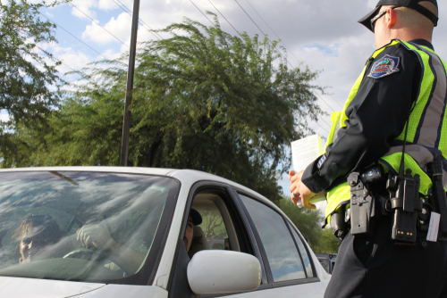 Tampa Drug DUI lawyer shown through a police officer addressing a driver during a suspected drug-related DUI stop.