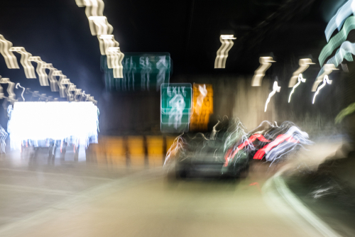 Tampa DUI manslaughter lawyer represented through a blurred, impaired-driving scene showing a car swerving inside a tunnel.