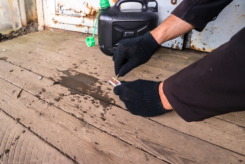 Tampa arson defense lawyer illustrated through a gloved person striking a match beside spilled accelerant, reflecting the seriousness of arson charges.