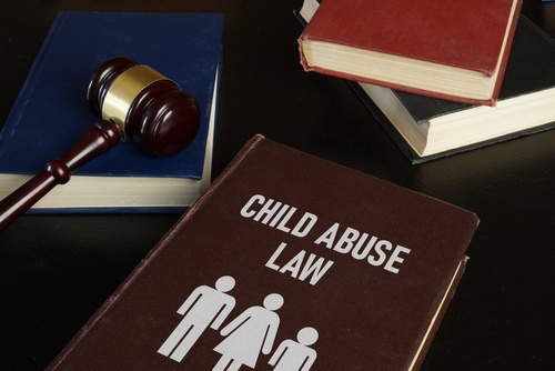 Book titled Child Abuse Law next to a judge’s gavel, illustrating cases handled with the support of a Tampa Child Abuse Lawyer.