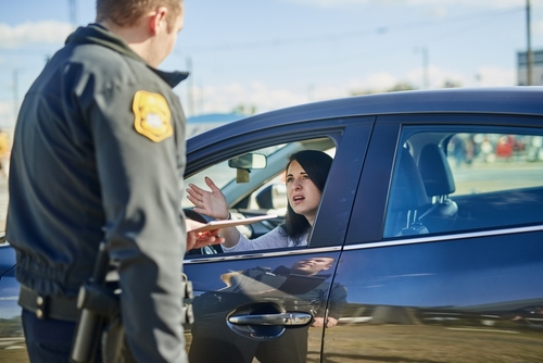 Florida DUI checkpoints shown as a police officer speaks with a driver during a roadside sobriety stop.