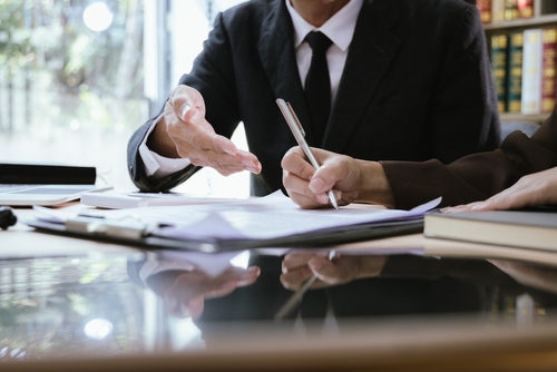 An attorney reviewing documents with a client at a desk, representing legal guidance provided by a Tampa personal injury lawyer.