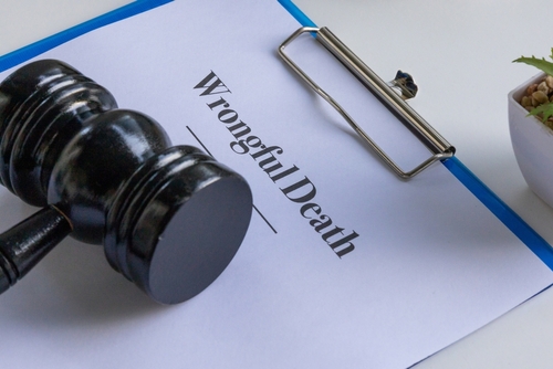 Gavel resting on a clipboard labeled “Wrongful Death,” symbolizing legal representation provided by a Tampa wrongful death lawyer.
